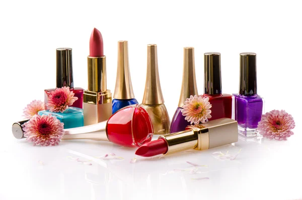 Nail polish and lipstick with flowers — Stock Photo, Image