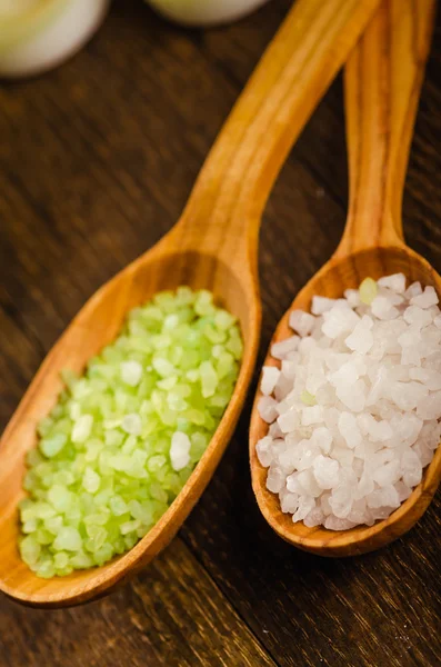 Wooden spoons with green and white salt — Stock Photo, Image