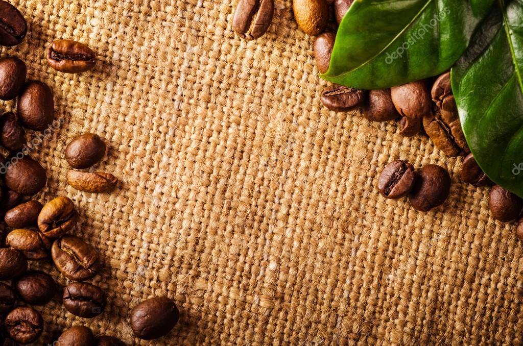 Coffee beans and coffee leaves on vintage background — Stock Photo