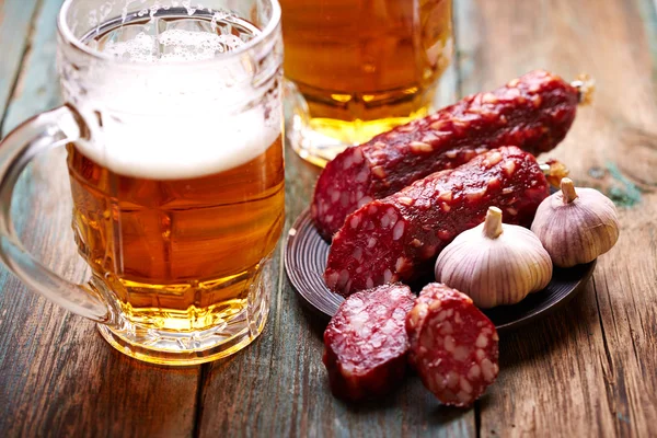 Beer with salami and garlic — Stock Photo, Image