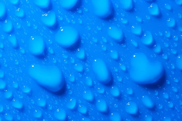 Macro Tiro Gotas Água Uma Superfície Plana Azul Fundo Azul — Fotografia de Stock