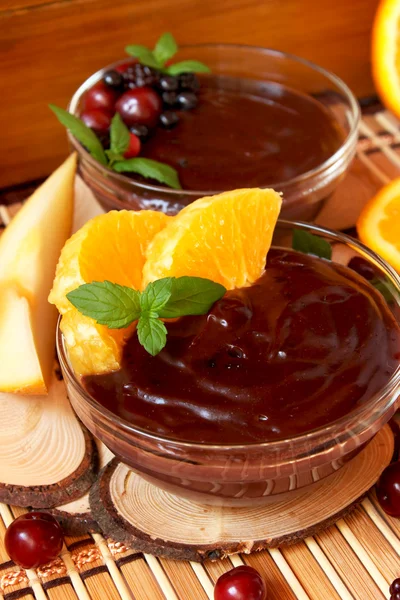 Chocolate pudding with orange slices and mint — Stock Photo, Image