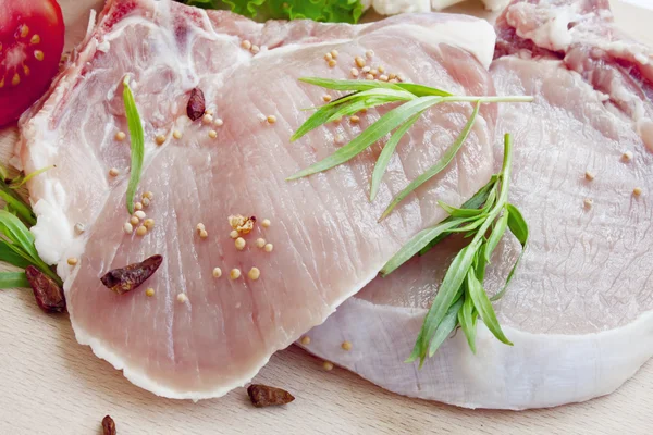 Raw pork chop fillets with spices — Stock Photo, Image