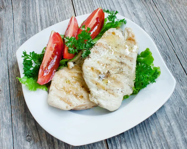 Grilled chicken breast on white plate — Stock Photo, Image