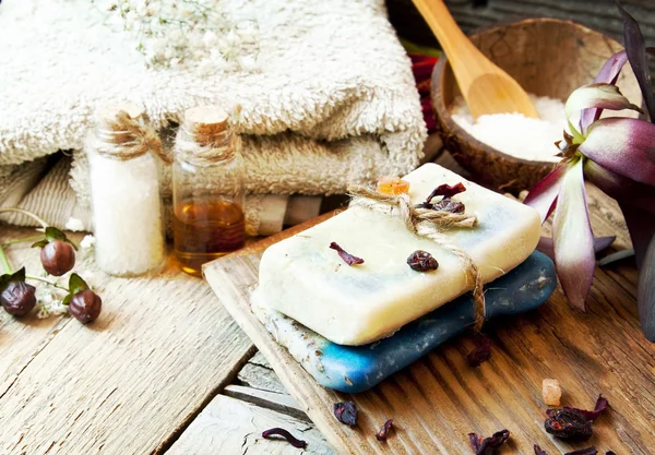 Spa Setting with Natural Soap, Essence Bottles, Towel, Sea Salt and Flower — Stock Photo, Image