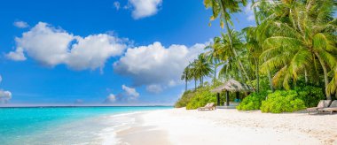 Panoramic landscape view of white beach sand sea water and blue sky clear background. 