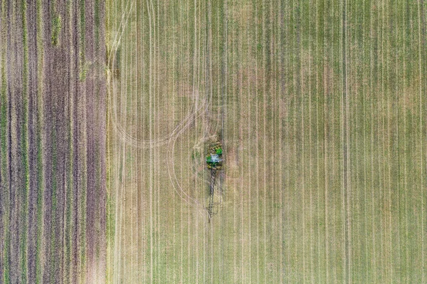 Aerial view of agricultural fields. Aerial top view photo from flying drone of a land with sown green fields in countryside in spring day. Agriculture landscape with grown plants