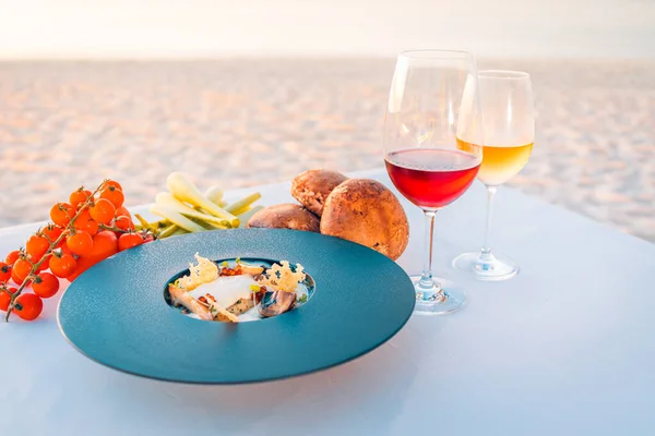 delicious dish on table on sea beach