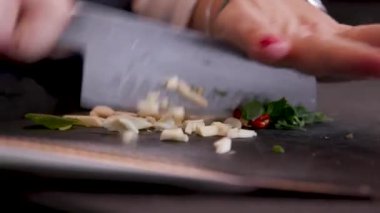 chef chops mushrooms for Italian dinner