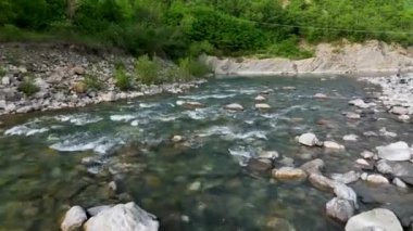 drone flies over the river at low altitude