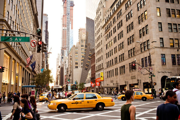 NEW YORK - AUGUST 21: Yellow taxis rides on 5th Avenue on August 21 2012 in New York, USA. 5th Avenue is a central road of Manhattan, the most expensive shops and apartmens situated here