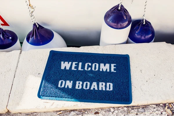 Welcome aboard mat on yacht — Stock Photo, Image