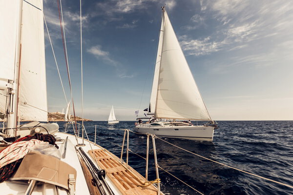 Sailing ship yachts with white sails