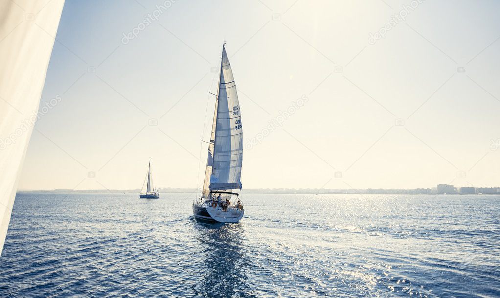 Sailing ship yachts with white sails