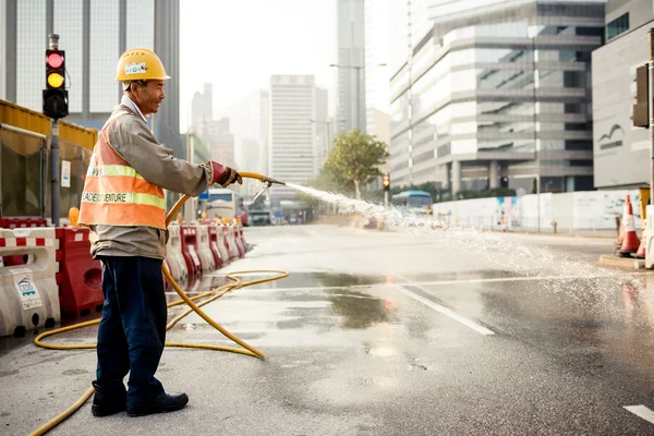 Man cleaning road in Hong Kong