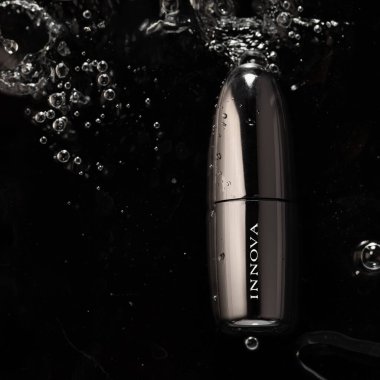 Istanbul  TURKEY - 08.11.2022: Metallic shiny Innova lipstick in water on black ground
