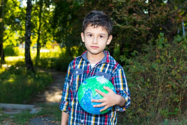 Boy Clutches Globe Himself Schoolboy Holds Globe His Hand Background — Stock fotografie