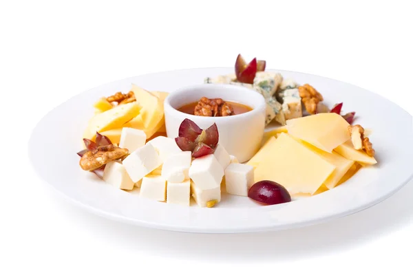 A plate with slices of cheese of different varieties — Stock Photo, Image