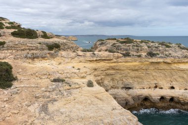 Sea rock arch in Portugal. Landscape of Praia da Marinha in Algarve region, Portugal.