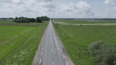 Plunge Bölgesi, Litvanya - 12 Haziran 2022: Bir traktör tarladan karavana balya yüklüyor