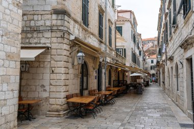 Dubrovnik, Croatia - 8 July 2022: One of the streets in old town with cafe in early morning.