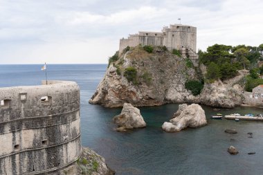Dubrovnik, Croatia - 8 July 2022: old town city view, old castle view, Ancient fortress view and houses, a castle on the sea bay, hand made walls build with old bricks and stones.