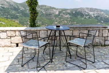 Chairs and table in the viewpoint under pergola.