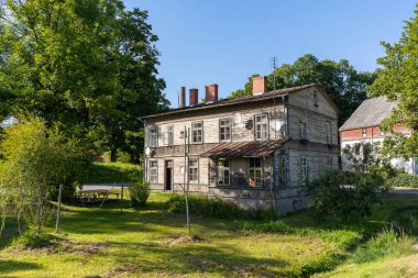 Two story wooden house of old style. Azipute, Latvia