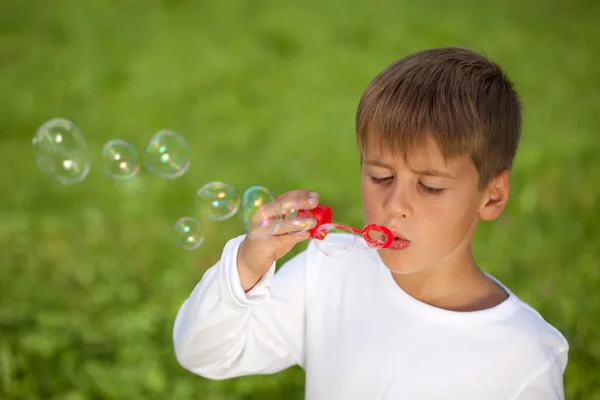 Мальчик веселится с пузырьками — стоковое фото