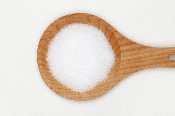 Sugar on a wooden spoon — Stock Photo, Image