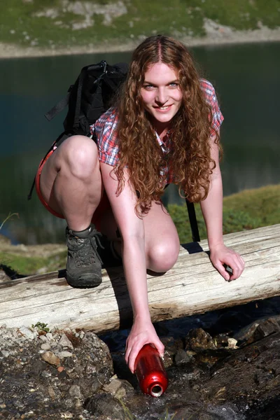 Bailing water from a brook — Stock Photo, Image