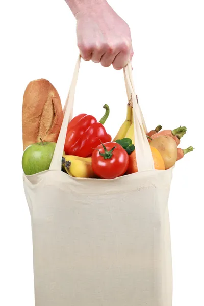 Hand holding a shopping bag filled with groceries — Stock Photo, Image