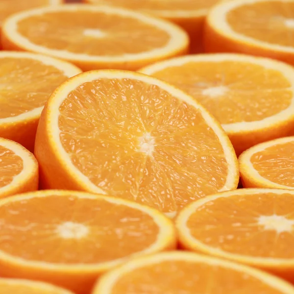 Sliced oranges forming a background — Stock Photo, Image