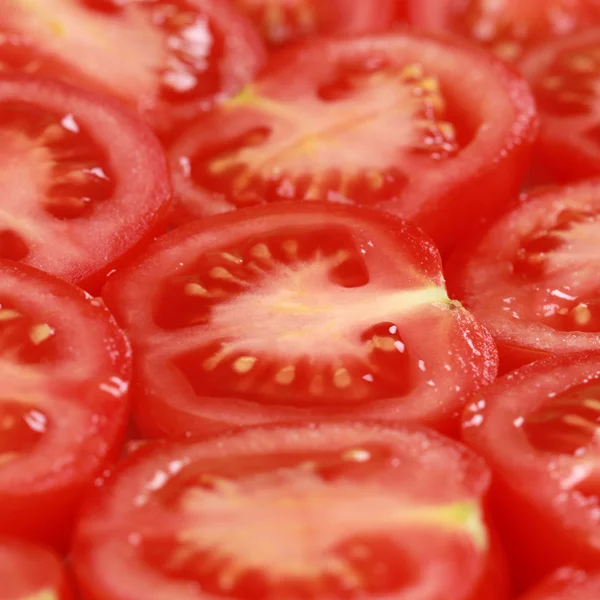 Krojone pomidory, stanowiące tło — Zdjęcie stockowe