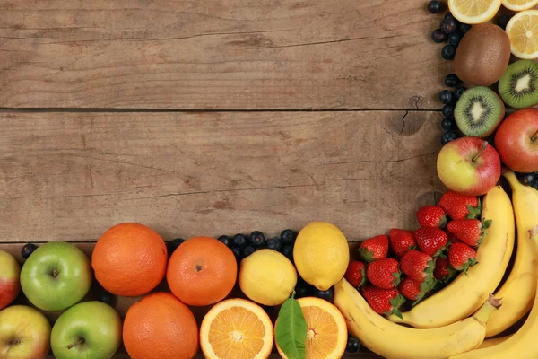 Fruits on a wooden board — Stock Photo, Image