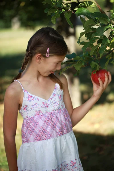 Little girl having an appetite for an apple — Stock Photo, Image