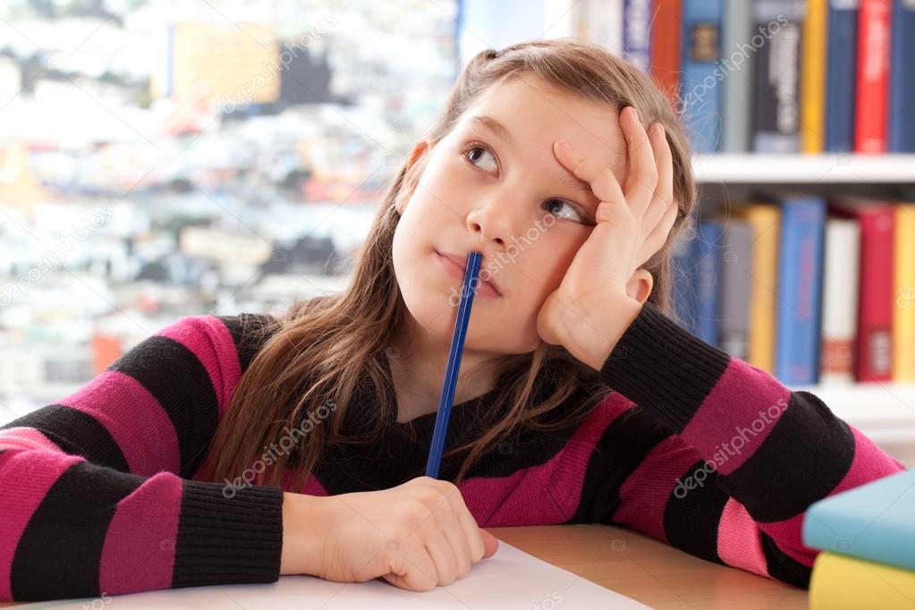 Schoolchild thinking while doing homework