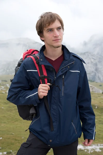 Portrait of young man hiking in the mountains — Stock Photo, Image
