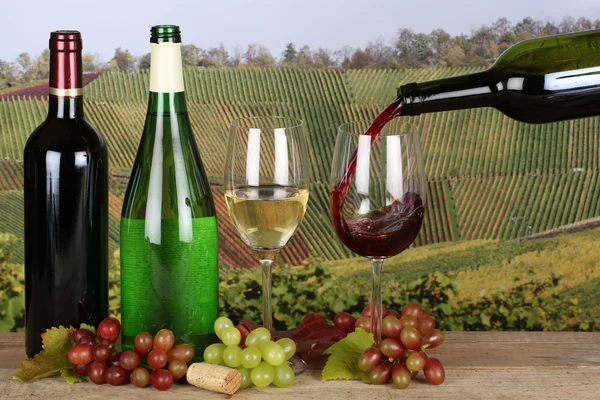 Wine pouring from a bottle into a wine glass — Stock Photo, Image