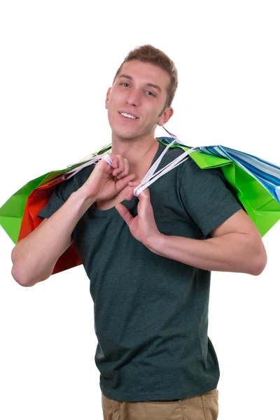 Jovem sorridente com sacos de compras — Fotografia de Stock