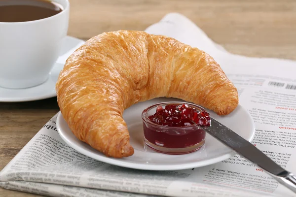 Breakfast with croissant, coffee and newspaper — Stock Photo, Image