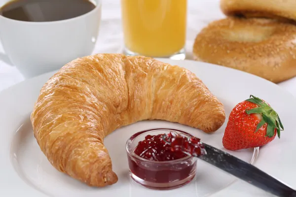 Breakfast with a croissant, coffee and orange juice — Stock Photo, Image
