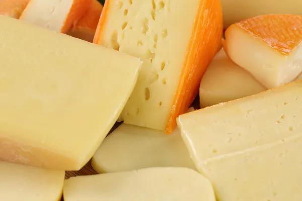 Cheese plate with Gouda, hard and Swiss cheese — Stock Photo, Image
