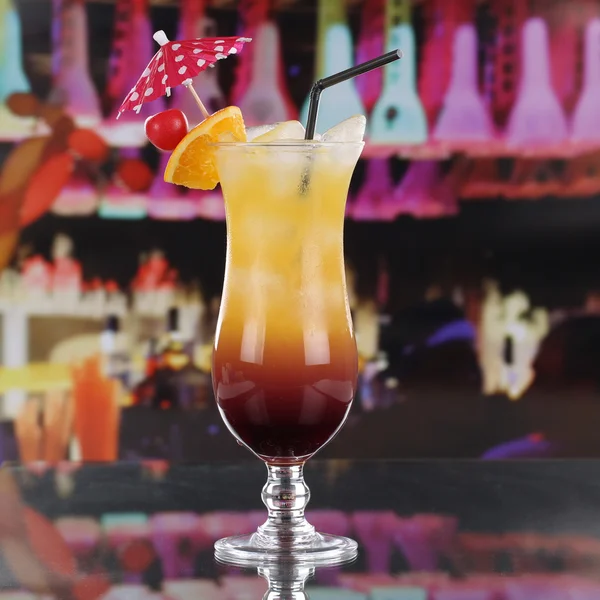 Tequila Sunrise cocktail with fruits on a bar counter — Stock Photo, Image