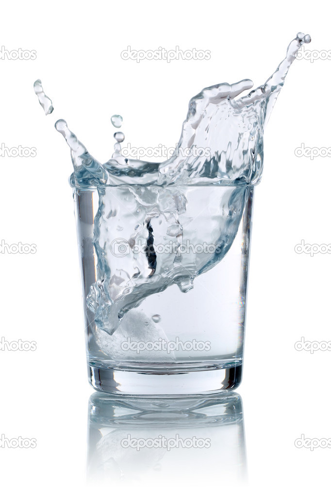 Ice cube splashing into glass with water