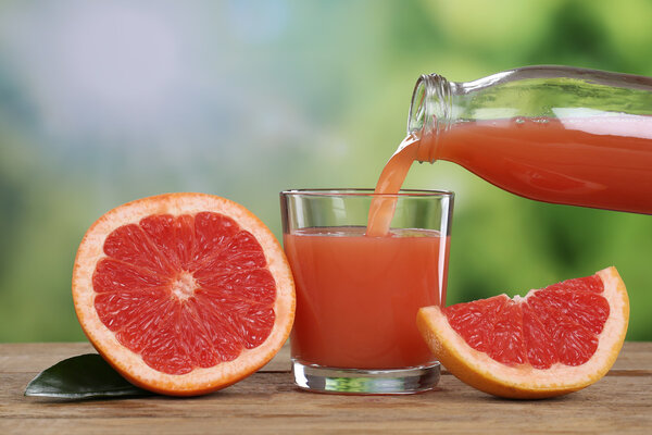Grapefruit juice pouring into a glass