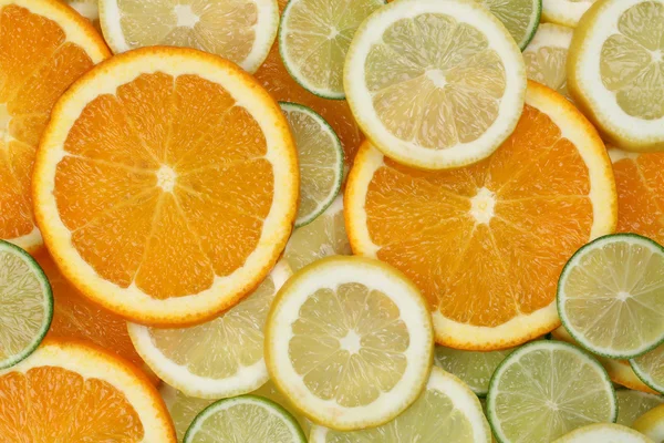 Sliced orange, lemon and limes background — 图库照片