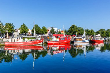 Almanya 'nın Rostock kentinde seyahat eden teknelerle dolu liman kornişleri.