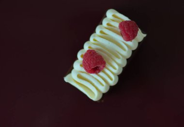 View from the top on delicious cake with two raspberries on top