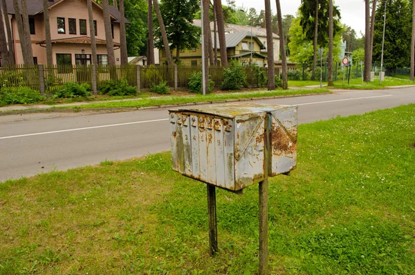 Old rusty mailboxes retro wooden houses district — Stock Photo, Image